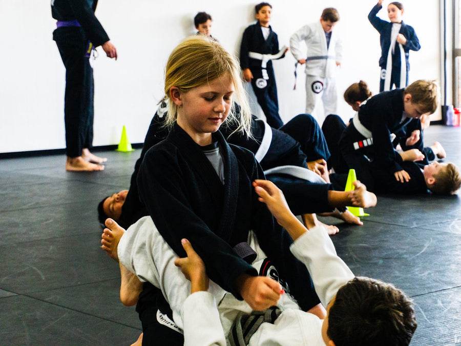 Youth students drilling guard techniques in the Kids 4 Brazilian Jiu Jitsu class at Studio 55 Loganholme
