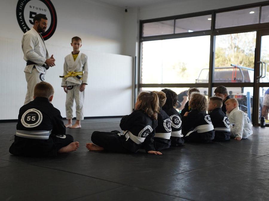 Kids Brazilian Jiu Jitsu class listening to Professor Paulo Lima at Studio 55 Loganholme